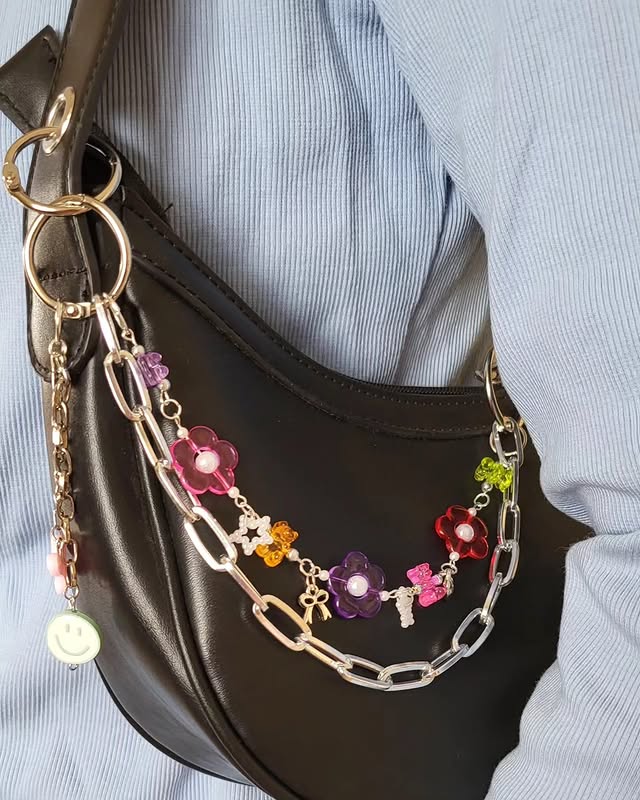 Pastel flower bag charm on a black bag